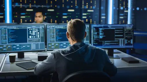 Shell employee working in information risk management and cyber security looking at computer codes