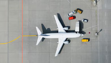 Aerial view of airplane and vans